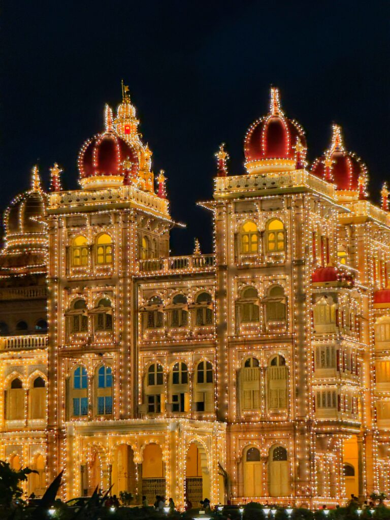 A breathtaking view of the illuminated Mysore Palace at night, showcasing its stunning architecture and grandeur.