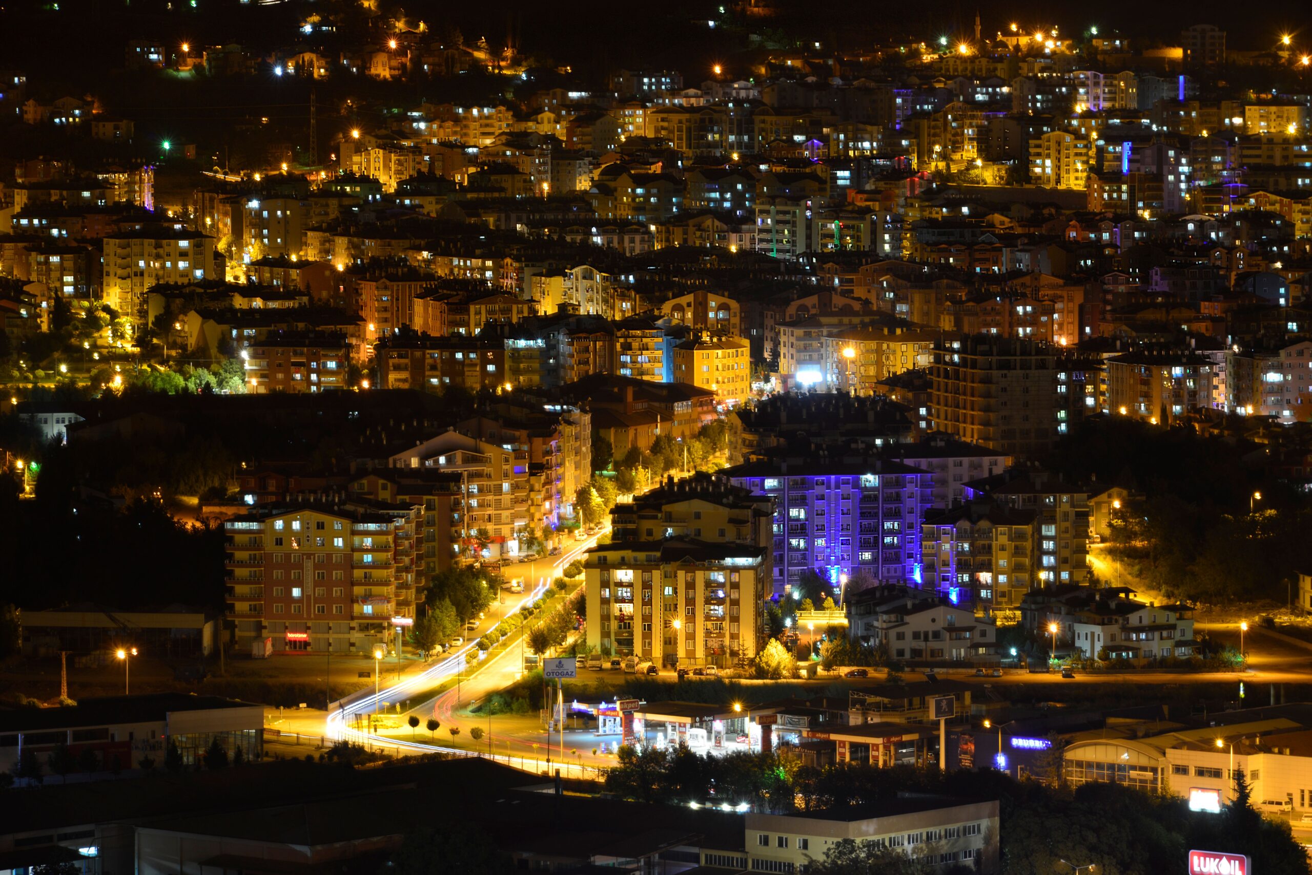 A stunning cityscape at night showcasing vibrantly lit buildings and streets.